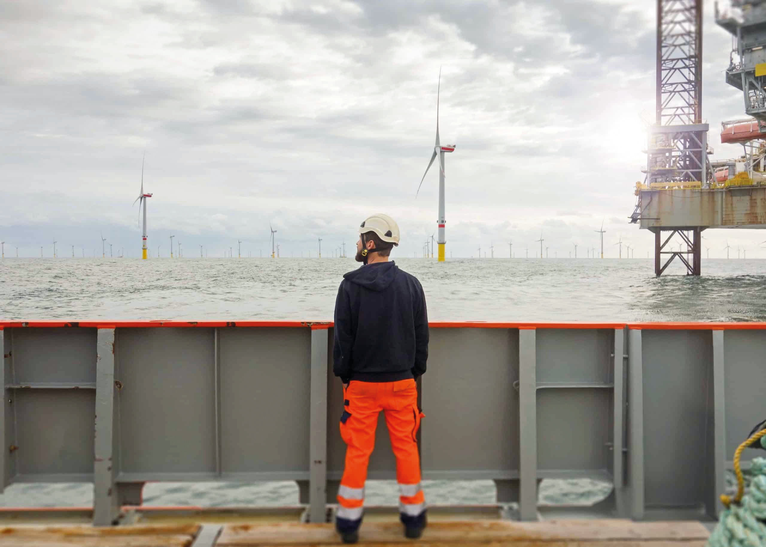 A man on a ship staring out to sea